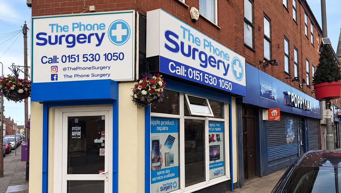 The Phone Surgery shop front on County Road, with blue and white signs, next door to the Tropicana chip shop